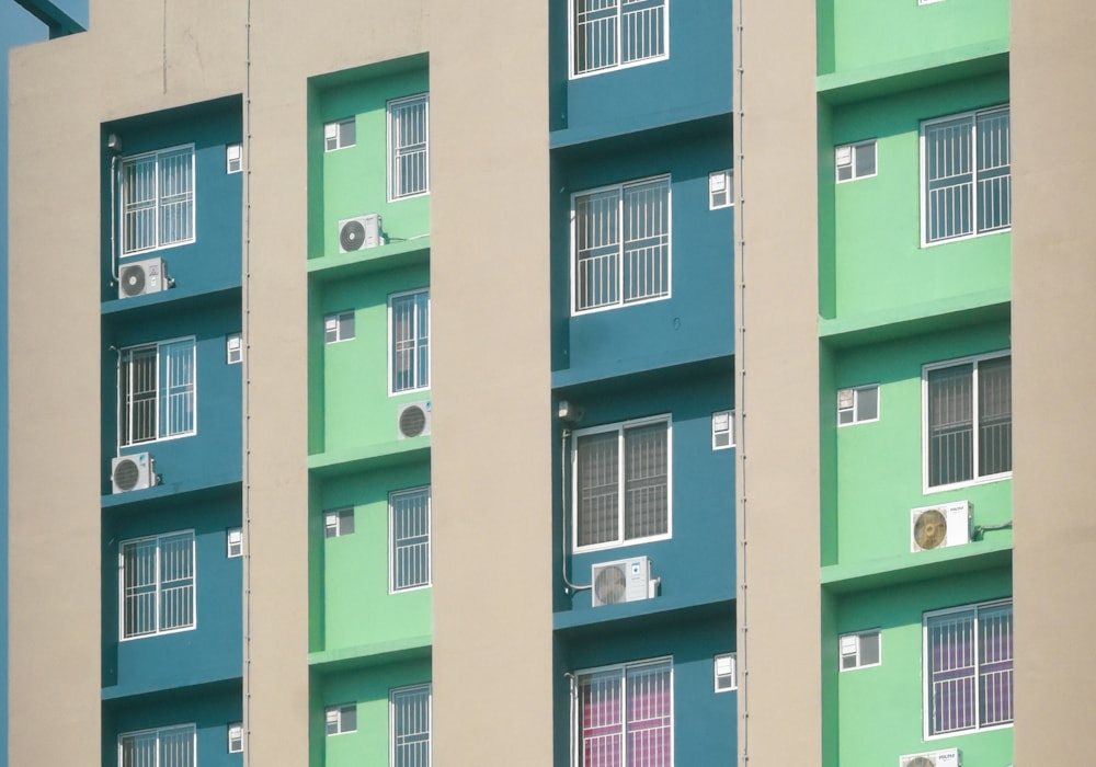 A colourful Indian apartment facade with rows of balconies and windows