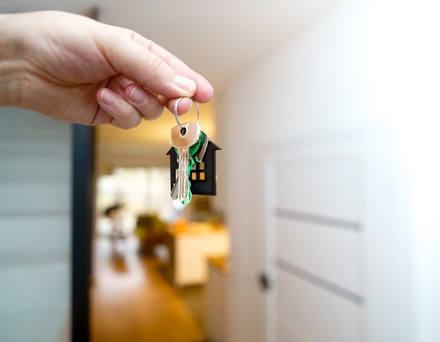 A hand holding new house keys at the door of a finished home